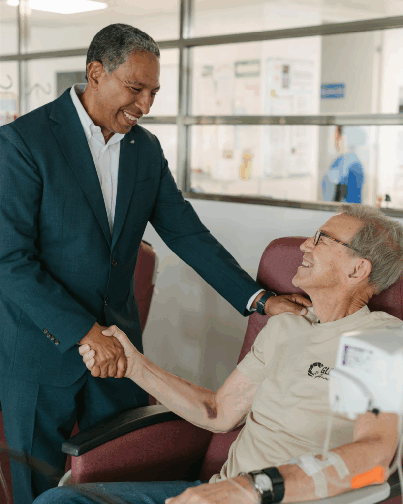patient receiving IV therapy and talking to a doctor