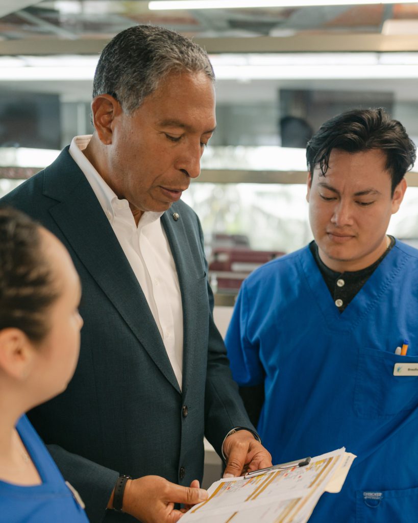 Dr. Tony Jimenez speaking with a patient at Hope4Cancer