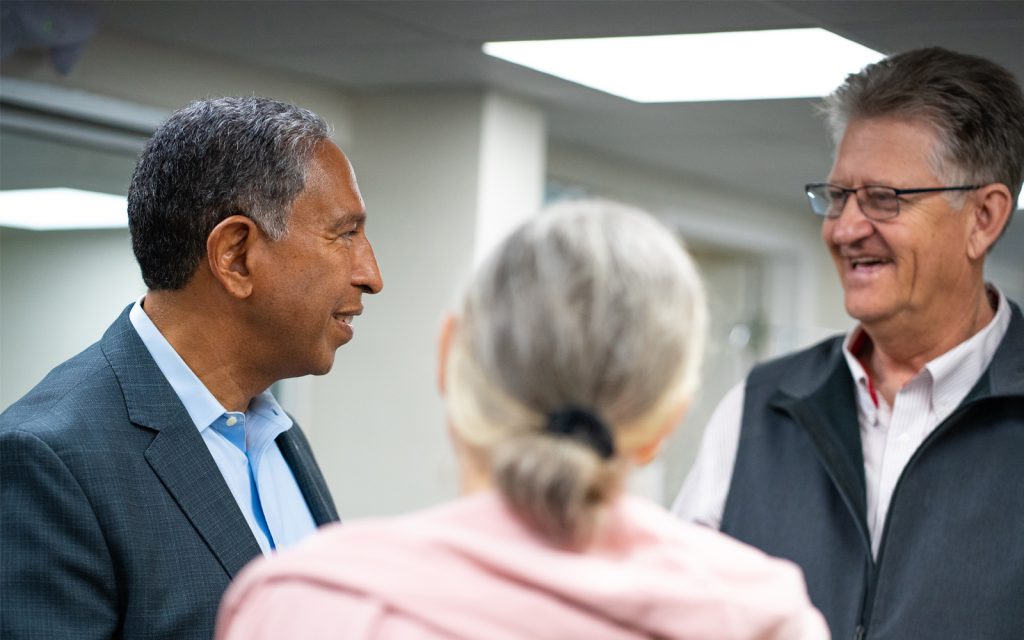 Dr. Tony Jimenez speaking with a family at Hope4Cancer